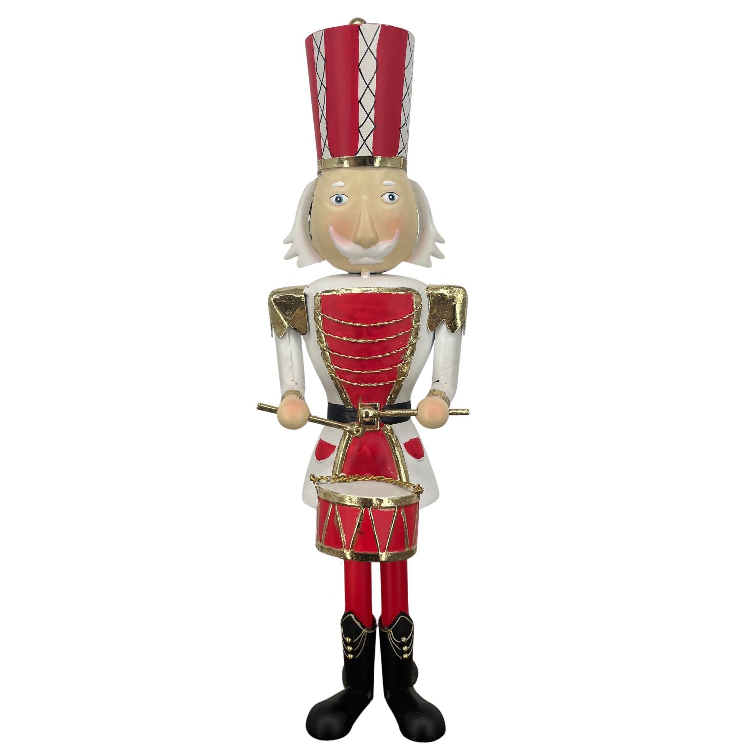 A traditional metal Christmas nutcracker figurine dressed in a red and white uniform with gold trim, a red and white striped hat, and black boots, holding a small drum against a plain white background.