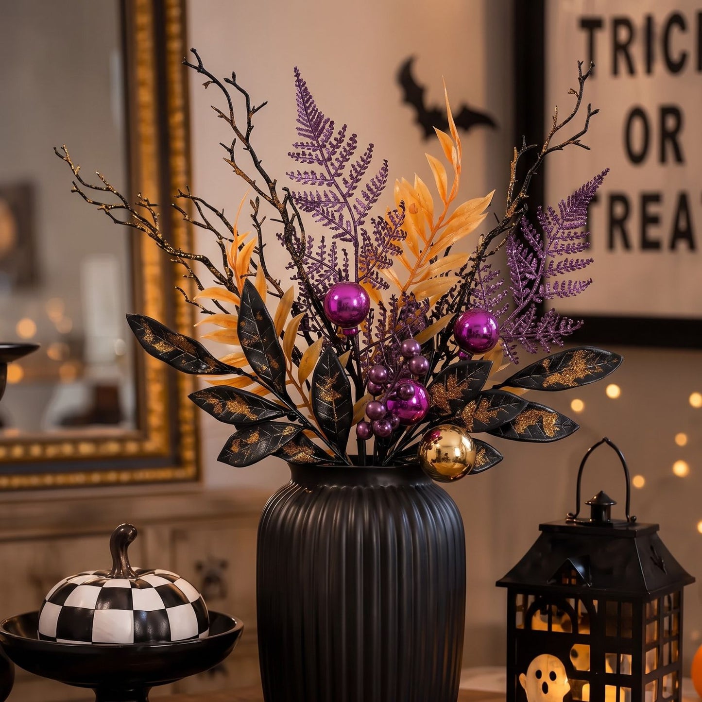 Halloween floral centerpiece in a ribbed black vase, featuring purple and gold faux foliage, black branches, glossy purple and gold ornaments, styled on a tabletop with a checkerboard pumpkin and a lantern in a warmly lit room.