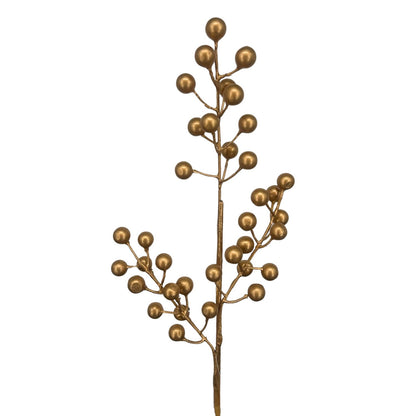 Gold artificial Christmas Berries against a white background.