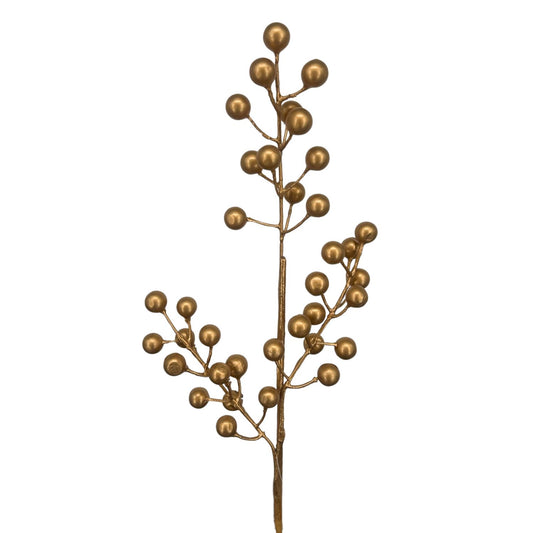 Gold artificial Christmas Berries against a white background.